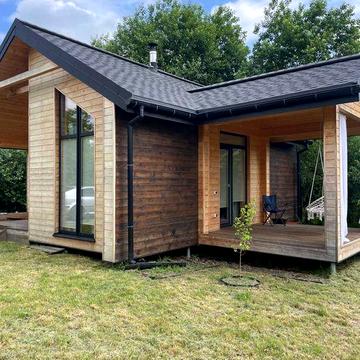 Сучасний будинок 45 м² з каміном і терасою біля лісу.