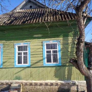 На березі річки *Вага*, деревяні будинки