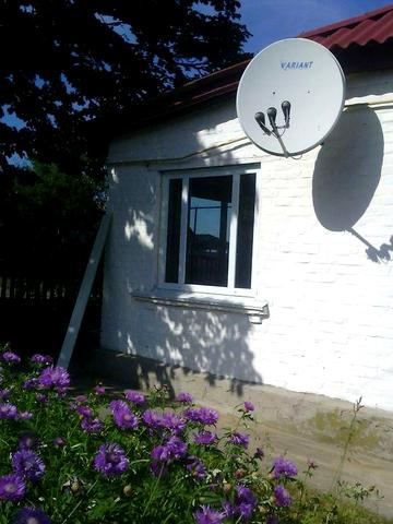 Будинок деревяний обкладений цеглою